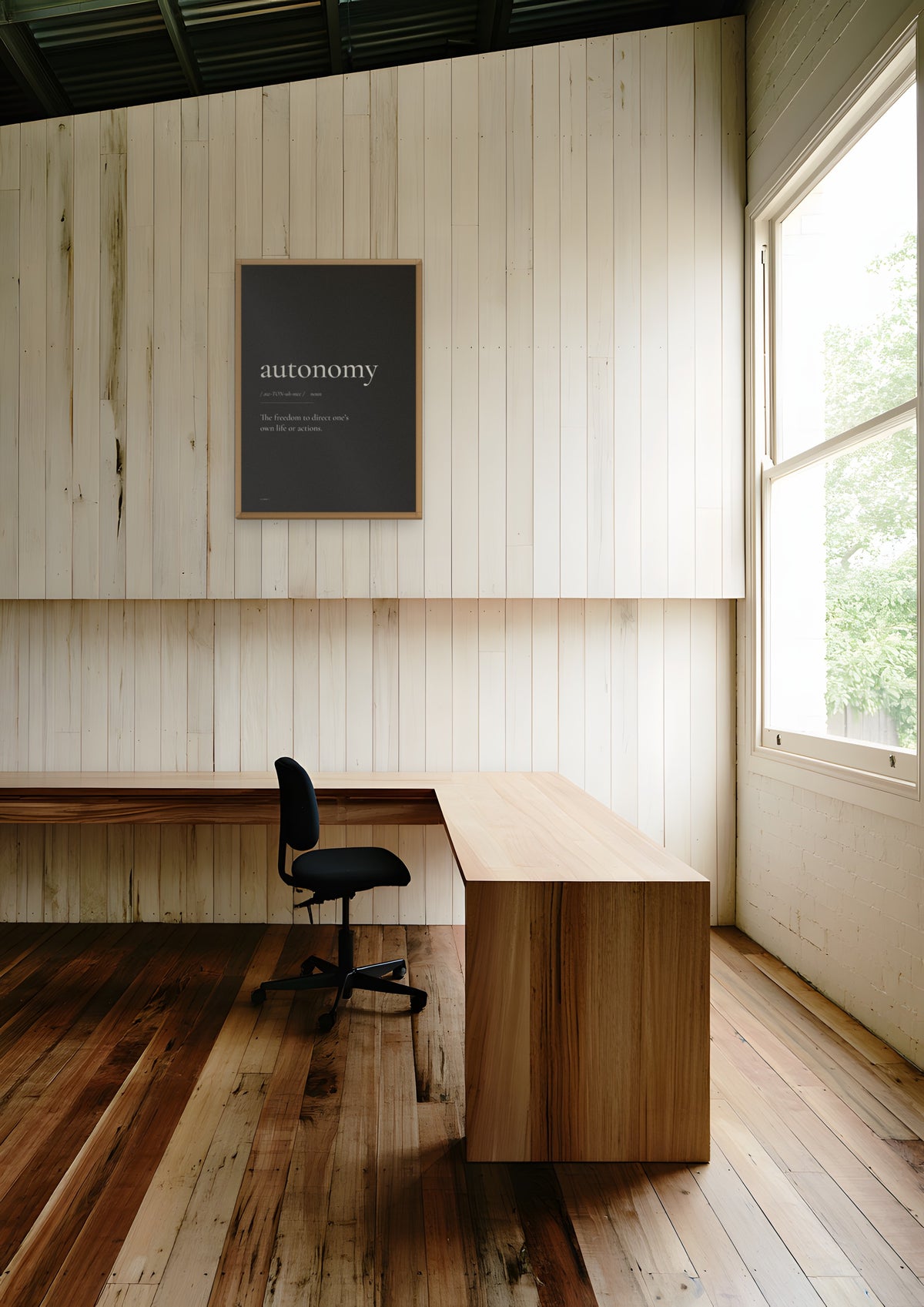 Autonomy (Black) in a natural wood frame, shown in melbourne-warehouse-office