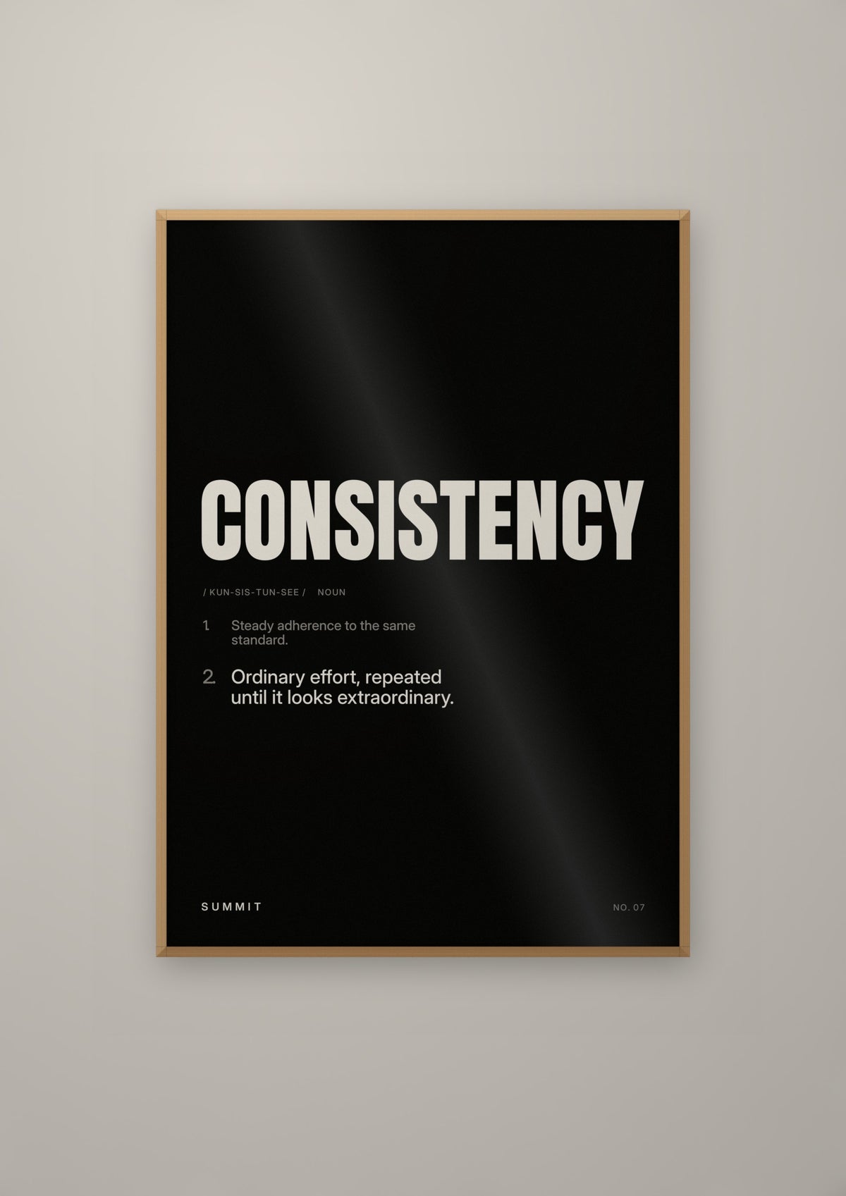 Consistency, Defined (Black) in a natural wood frame