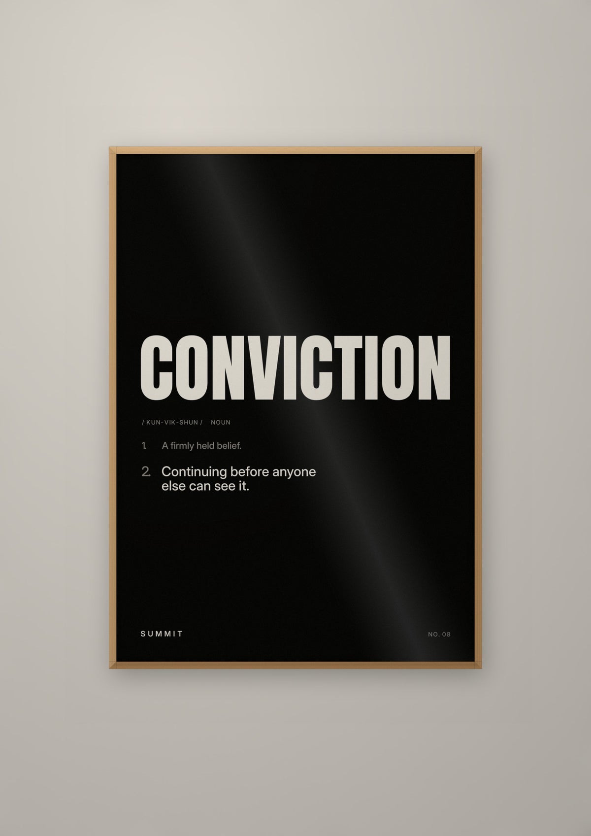 Conviction, Defined (Black) in a natural wood frame