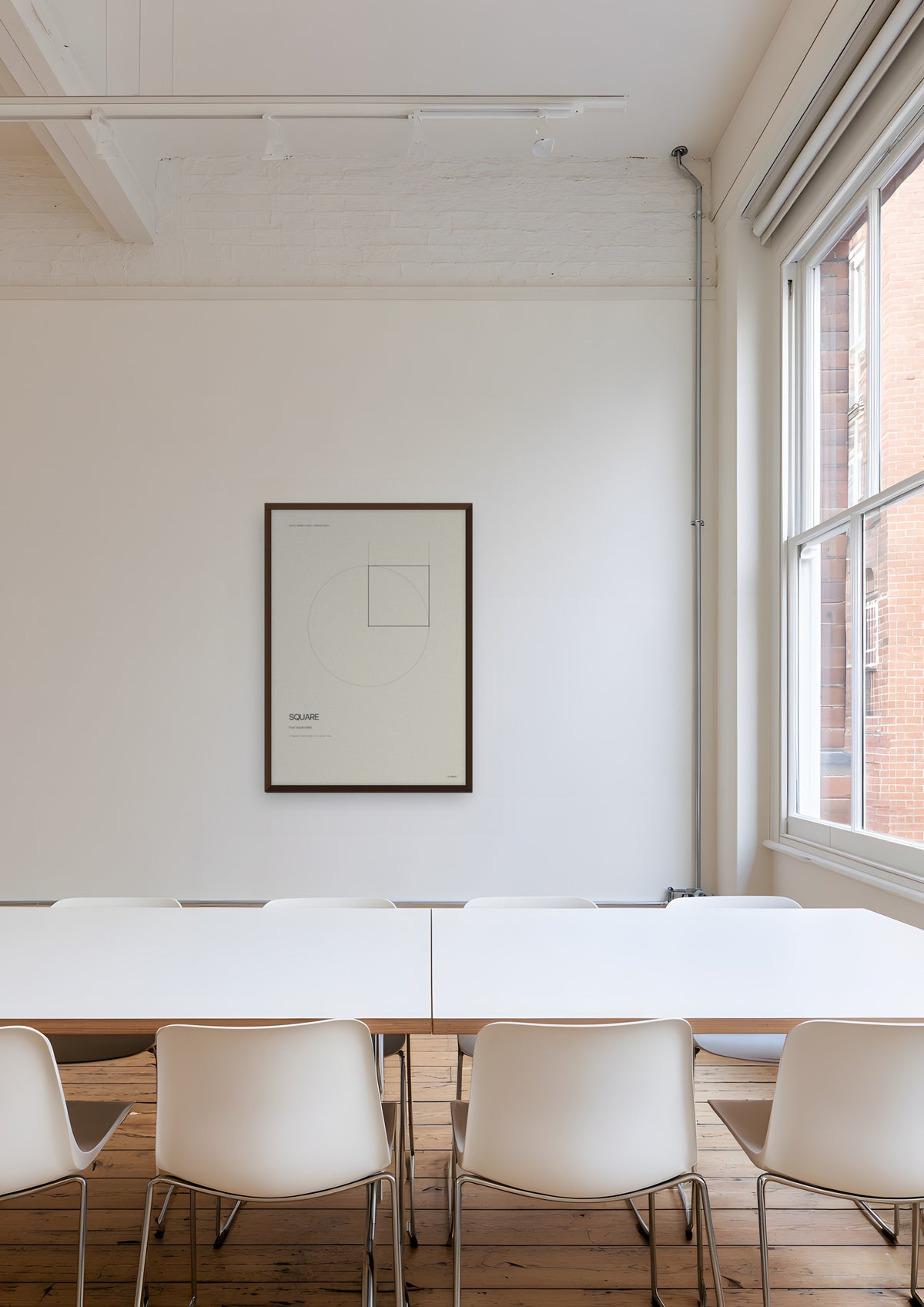 Square in a dark wood frame, shown in farringdon-architects-meeting-room