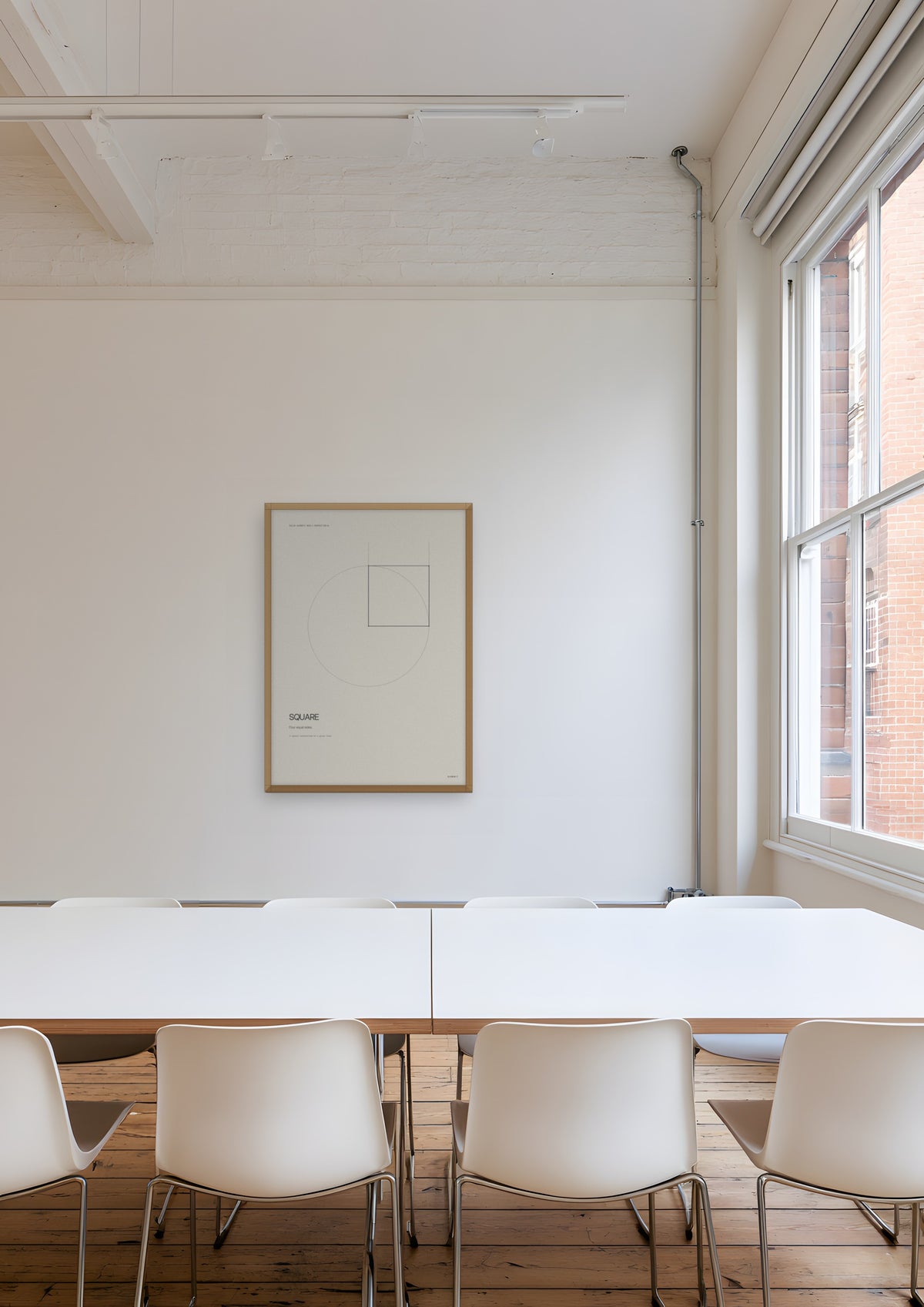 Square in a natural wood frame, shown in farringdon-architects-meeting-room