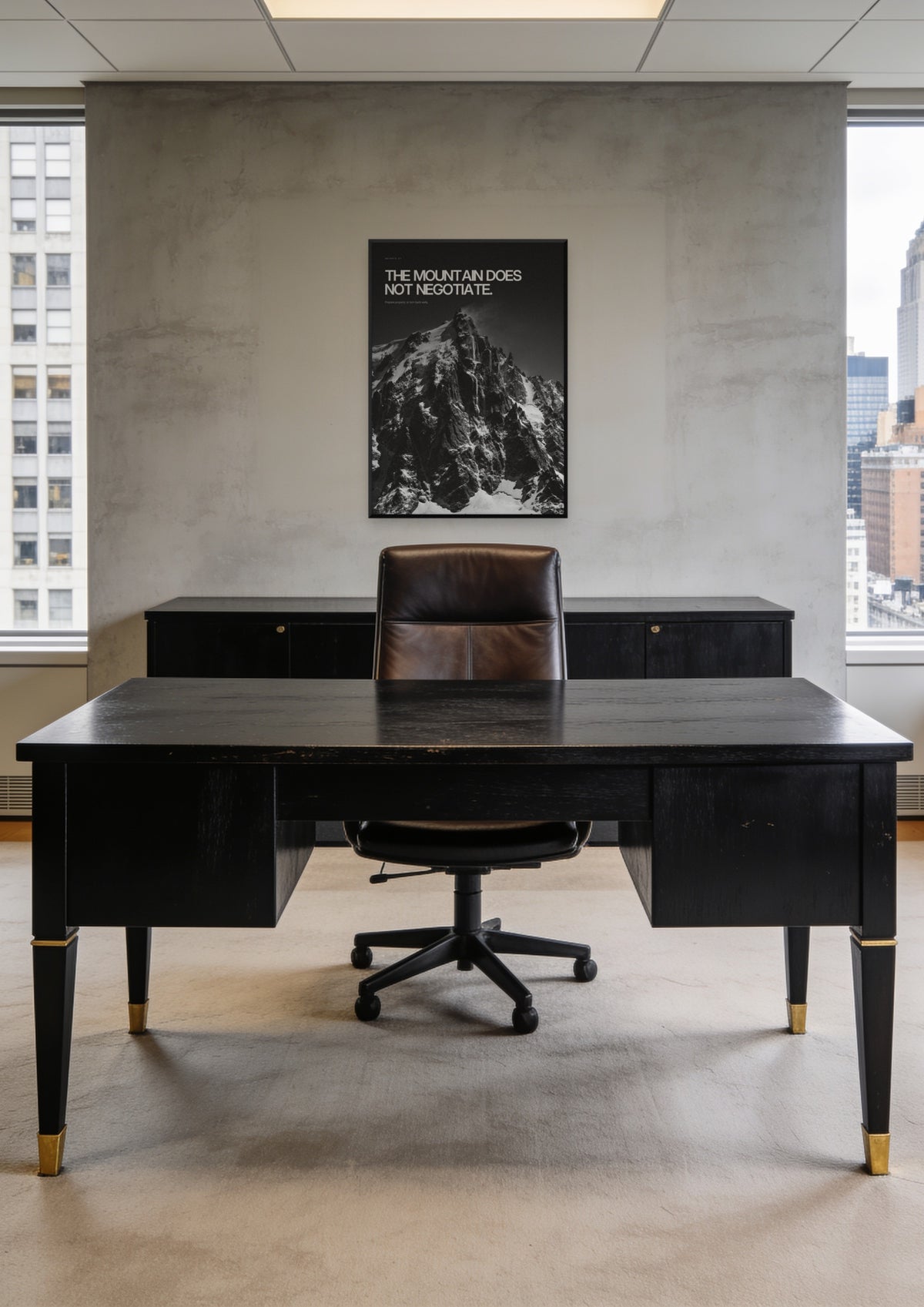 The Mountain Does Not Negotiate in a black frame, shown in a Midtown Manhattan office