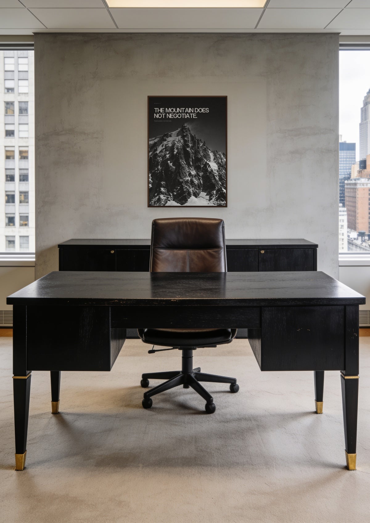 The Mountain Does Not Negotiate in a dark wood frame, shown in a Midtown Manhattan office