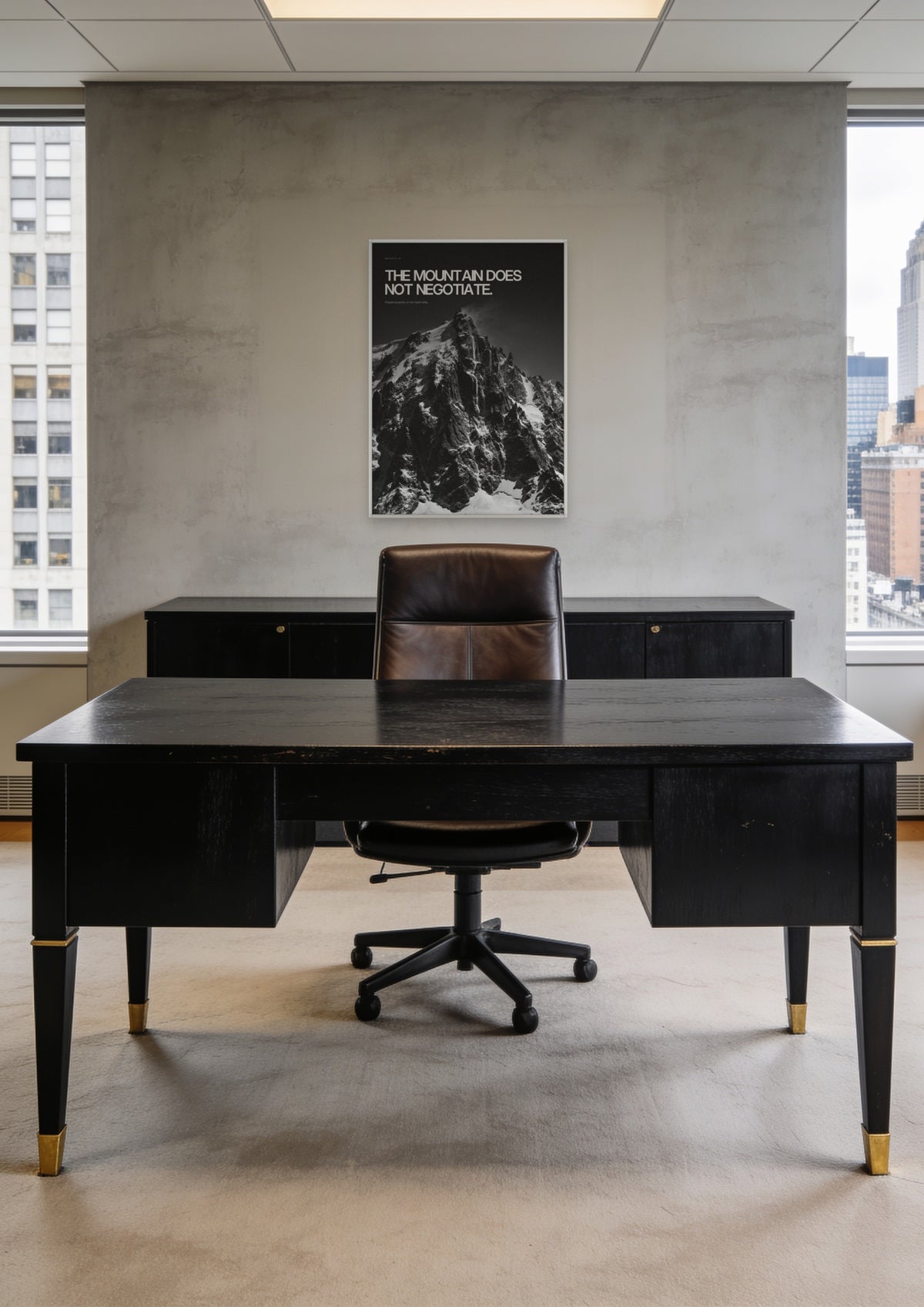 The Mountain Does Not Negotiate in a white frame, shown in a Midtown Manhattan office