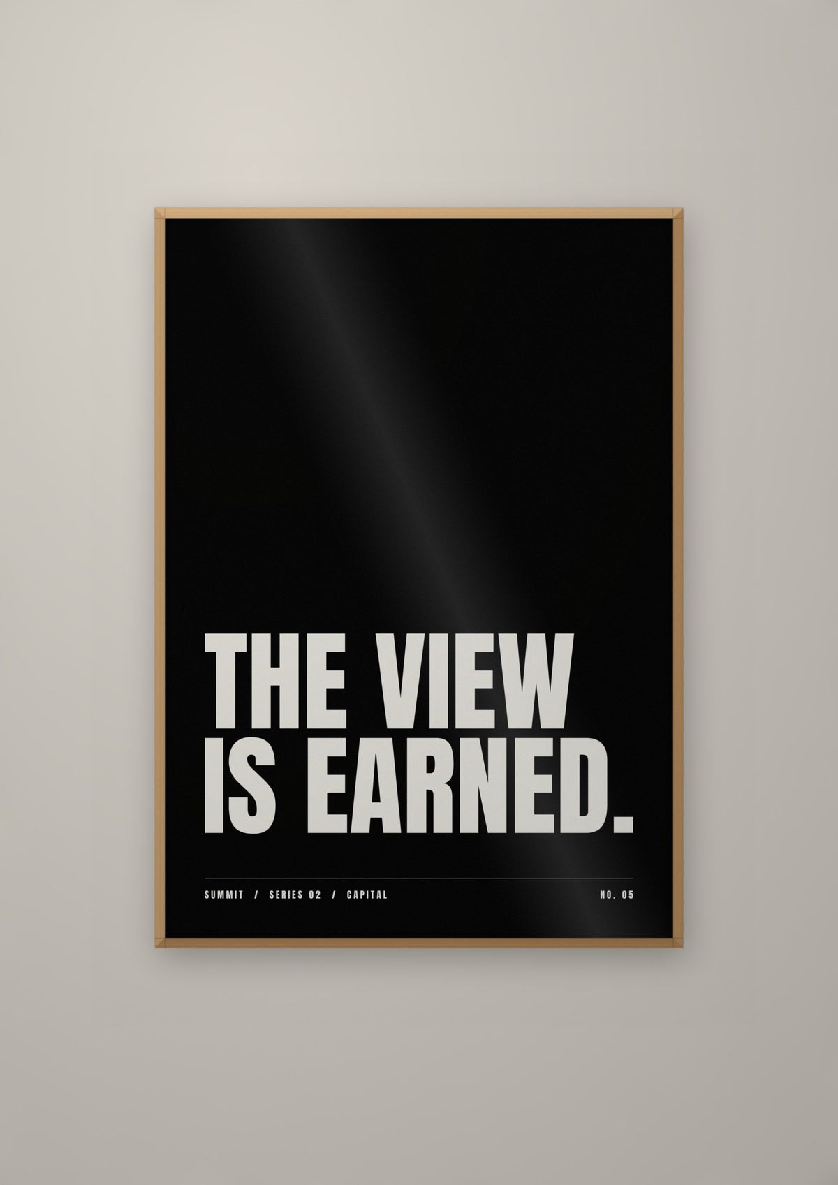 The View Is Earned in a natural wood frame