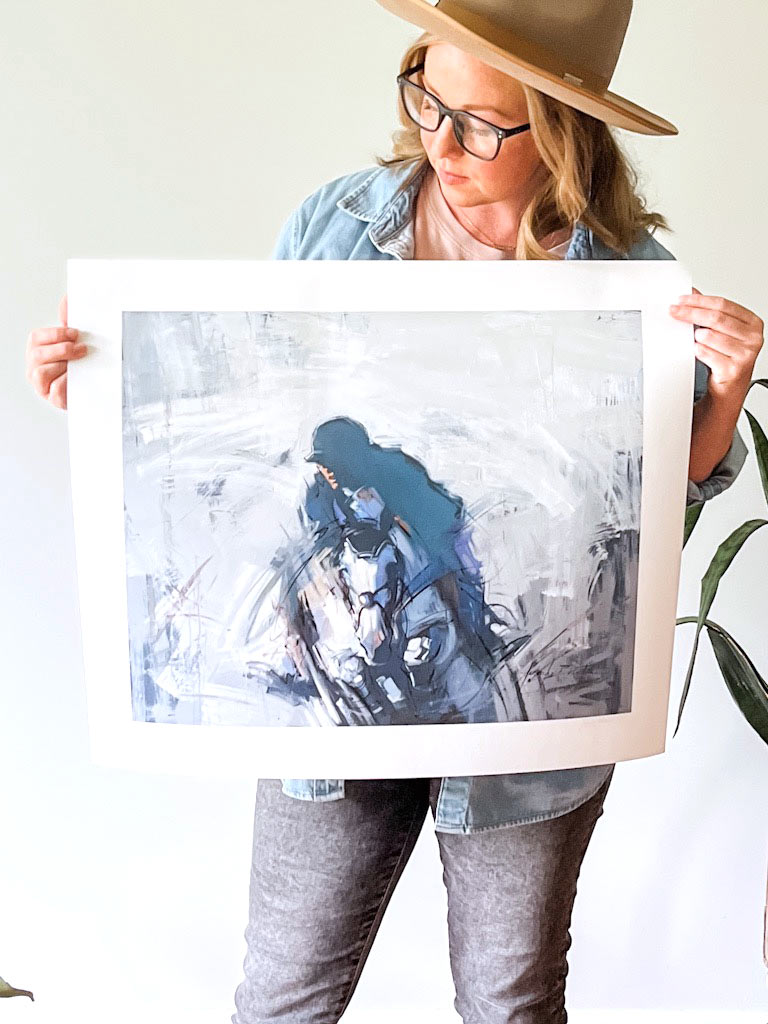 woman holding giclee print on paper